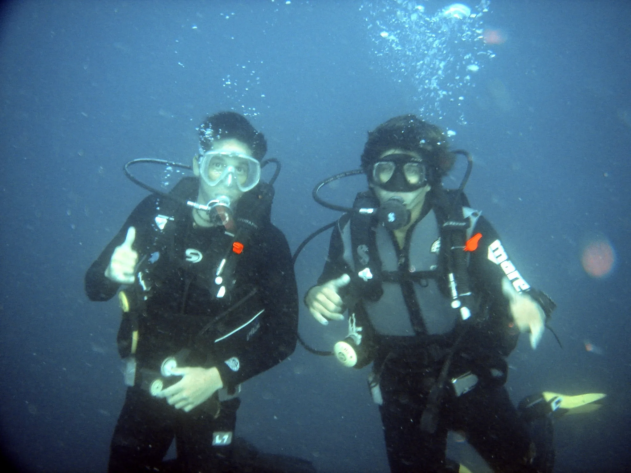 FiveMeters restoration of Divers at 30 metres: Faces and hands regain warmth while black suits, grey jackets and deep blue water stay distinct.